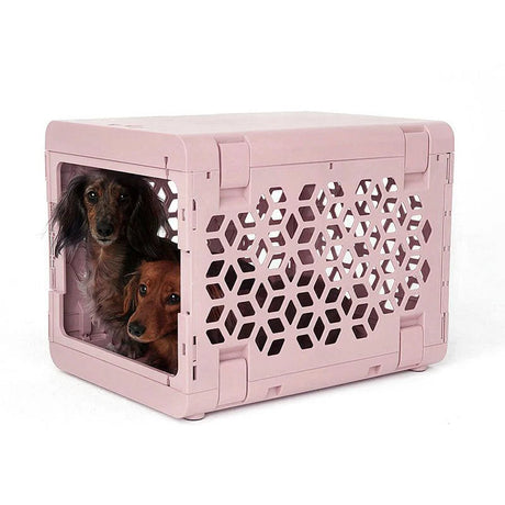 PAWD Crate in Pink. A modern, collapsible, and lightweight pet crate is easy to set up and blends nicely with your home decor.