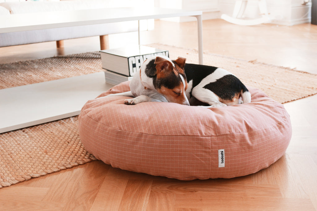 Dog sleeping on Tadazhi Poespas Round Bed in Checkered Rose – Soft Organic Cotton Pet Bed in Home Interior